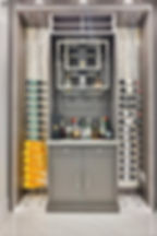 Luxury interior design featuring a modern home bar with built-in wine display racks