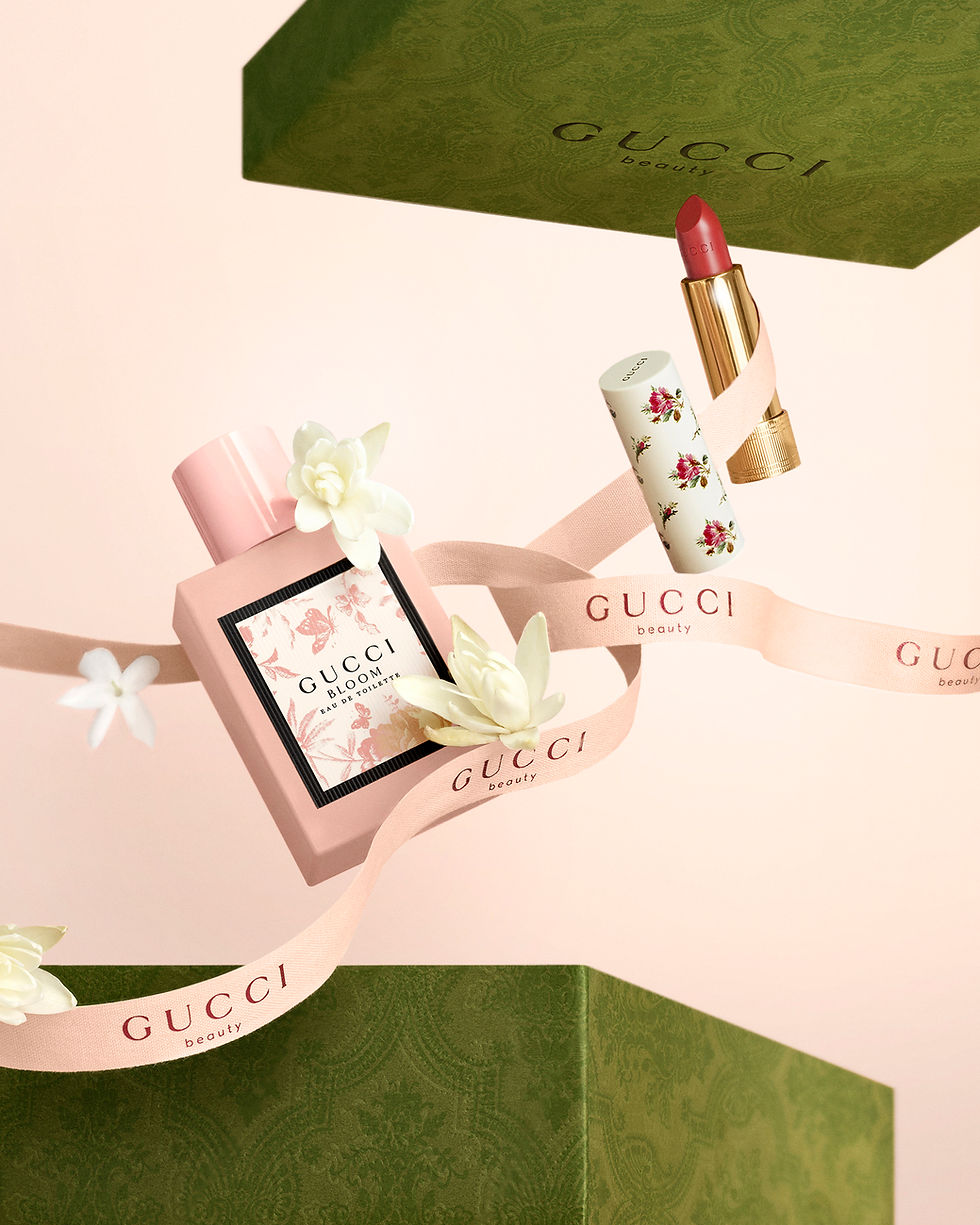 Gucci Bloom perfume and Gucci lipstick presented as luxury gift products in a premium beauty campaign concept.