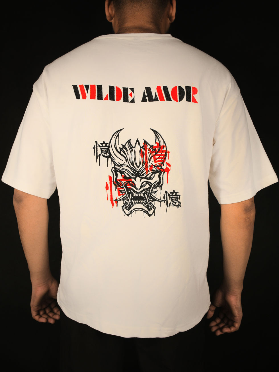 back view of off white oversized tshirt with embroidered demon face and wilde amor text.