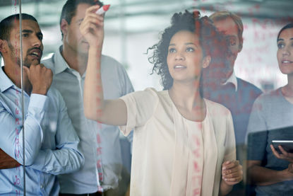 A leader working with her team during an Alpstra Leadership Development workshop