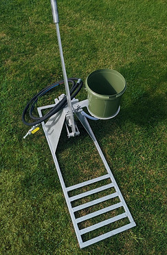 Photography of the Westy resin pump showing reservoir bucket and hoses