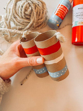 DIY cardboard pretend play binoculars using toilet paper rolls, acrylic paint, and yarn