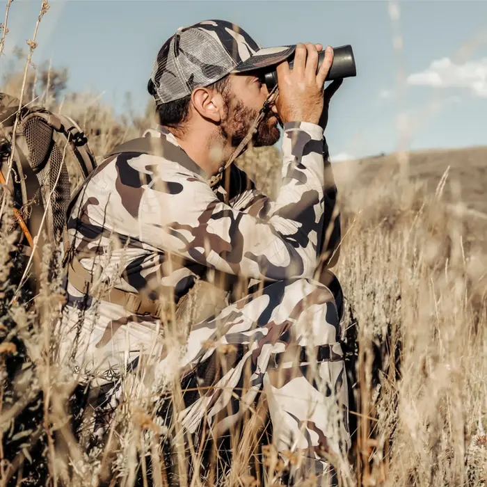 Weatherproof camo and layering systems designed for waterfowl marshes, mountain deer stands, and year-round comfort.
