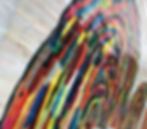 rainbows painted on a white wall, the rainbows are made of streaks of different colors instead of the traditional color arches 