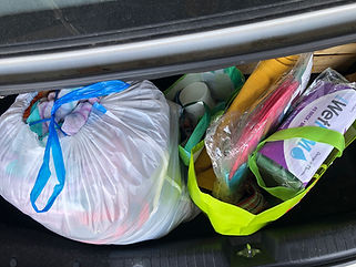 open car trunk with bags of donations