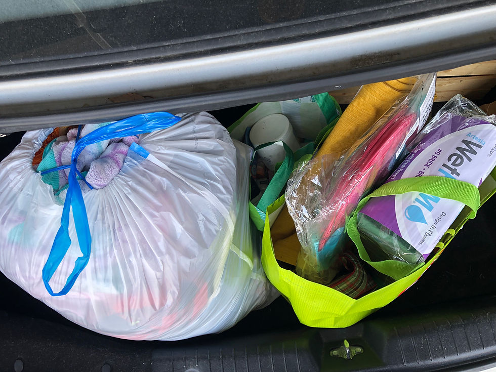 open car trunk with bags of donations