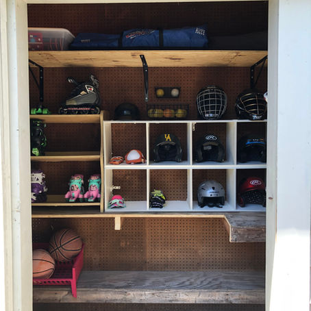 An organized shed for kids who play many sports.