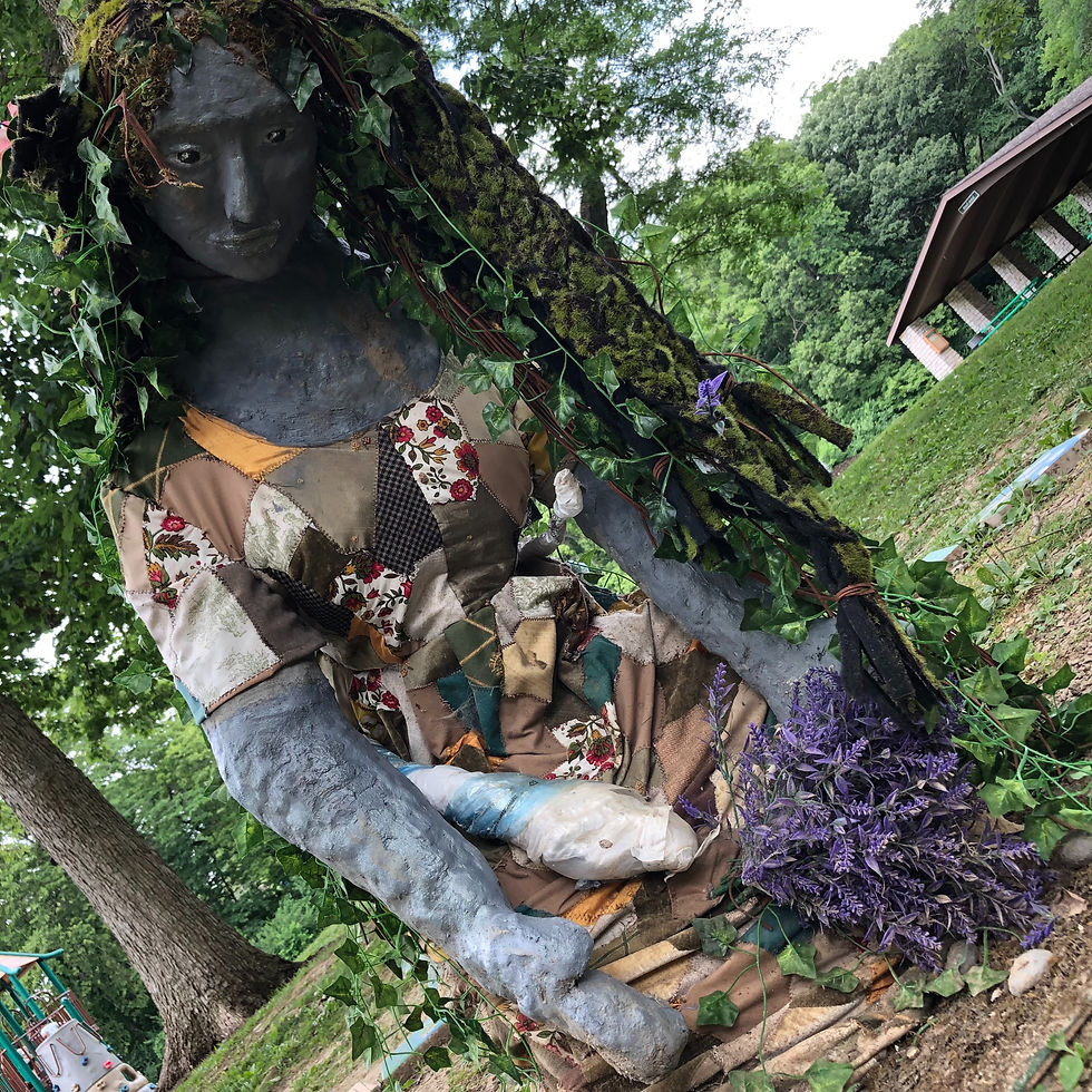 statue of a Mother Earth figure in a dress with vines for hair