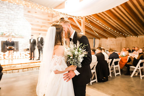 Indoor wedding ceremony in rustic venue in central Iowa