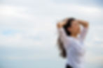 a-woman-with-her-hands-in-her-windblown-hair-on-a-2023-11-27-05-35-57-utc.jpg