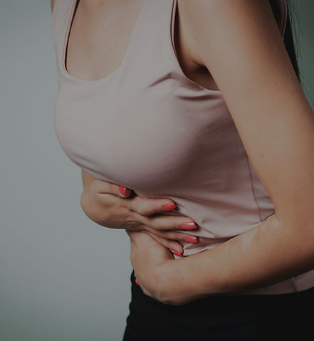woman with a pain in a hand on a gray background. health and medicine._edited.jpg