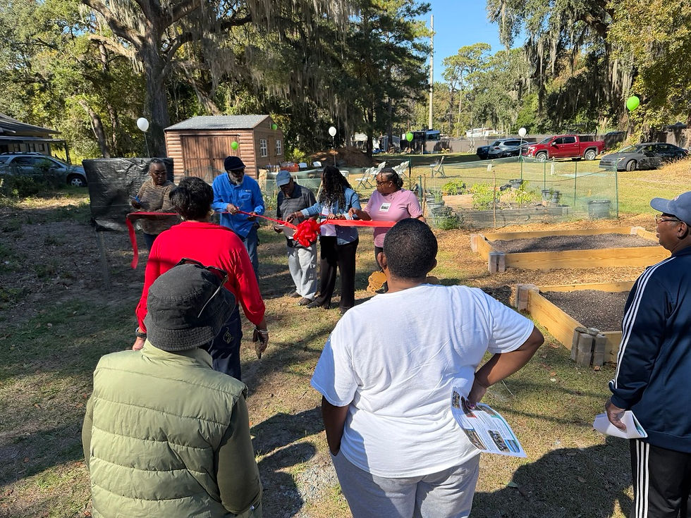 Members of the Pin Point Betterment Association and community members gather for the ribbon-cutting ceremony at the dedication of the John Anderson Sr. Community Garden.