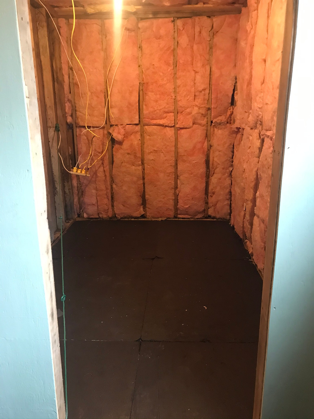 A small, dark, insulated, unfinished room. The before shot for our bunk room