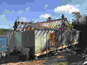 A Cabin on the ocean with the roof being constructed diy offgrid cabin