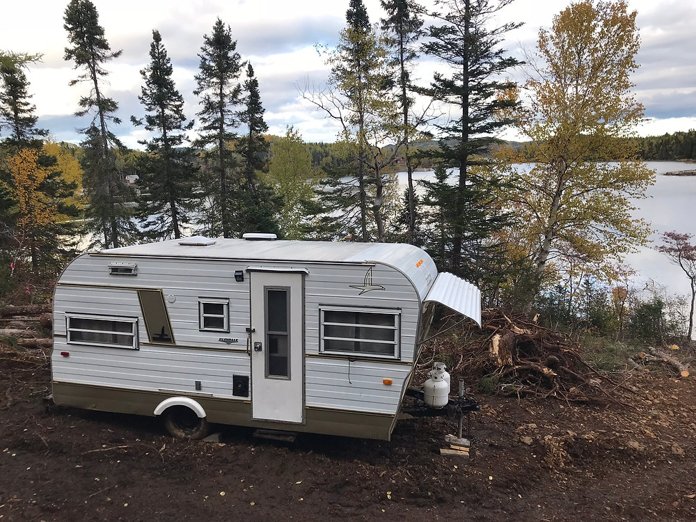 A 1960s Camper parked near the ocean at our diy cabin build