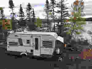 A 1960s Camper parked near the ocean at our diy cabin build