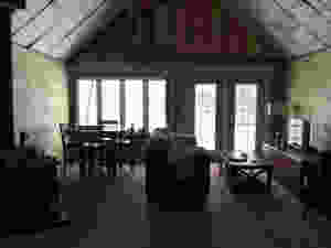 DIY cabin Living room with a view of the ocean through large window and door