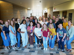 A large group of Bert Nash Center team members pose. Many are wearing Bert Nash shirts that say "I Believe in Mental Health."