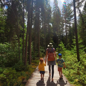 A mother hiking with her children after camping in Algonquin Park.
