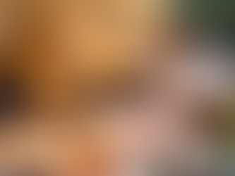 A woman relaxing with a book beside a safari tent and fire pit. This could be you at one of our Four Corners sites!