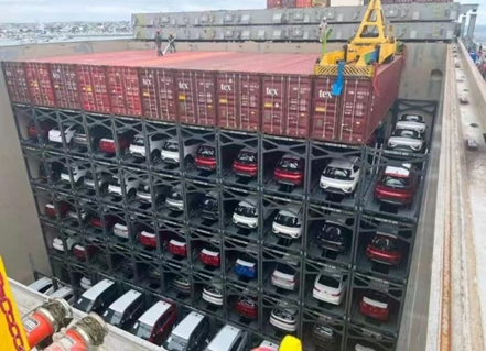 Vehicles loaded in flat-rack inside hold of ship