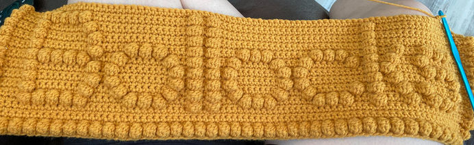 mustard colored crochet block with bobble stitches