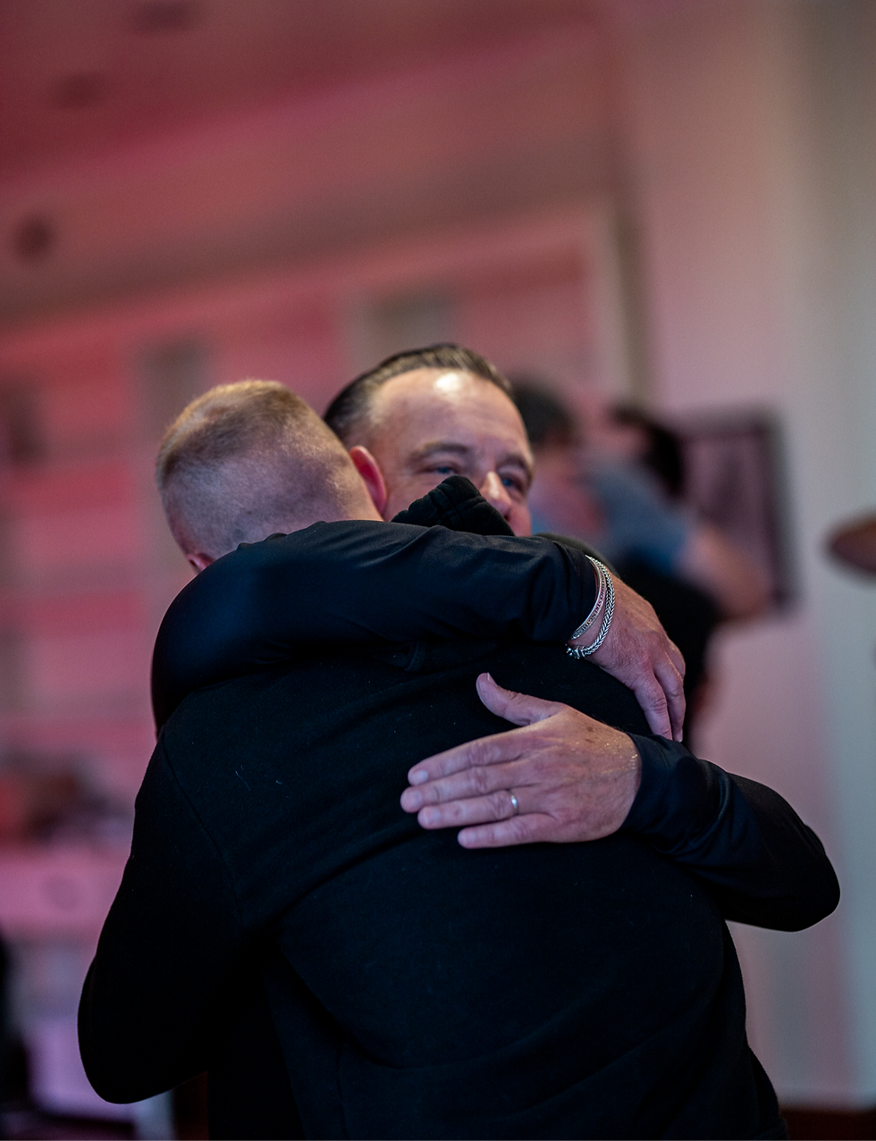 Two men hugging and showing compassion