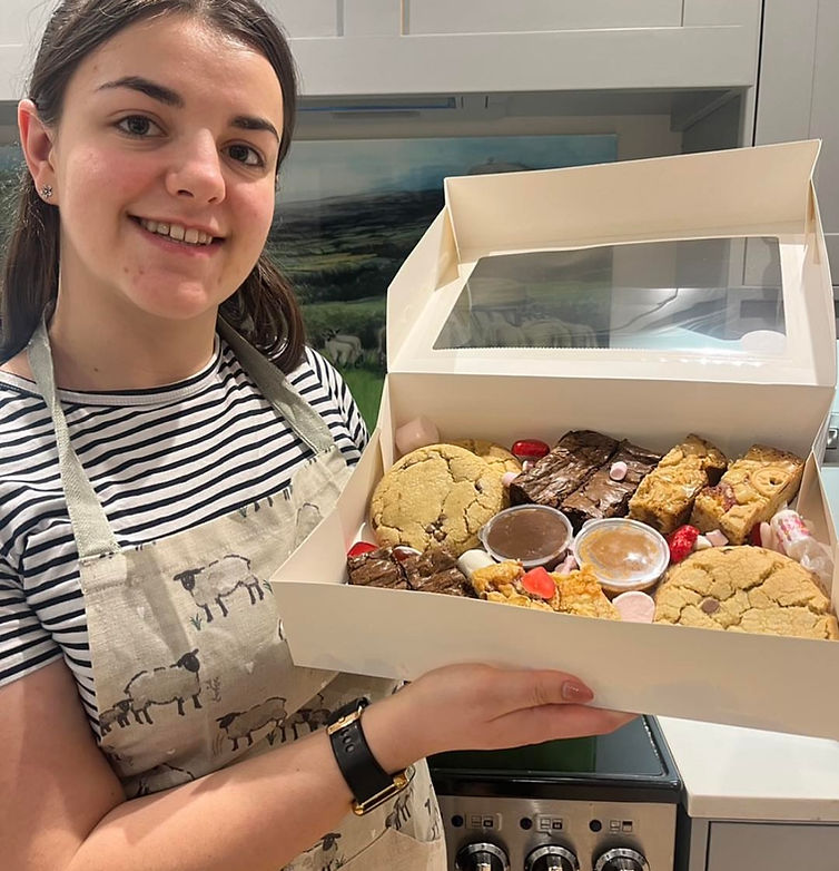 Owner of Border Bakes decorating a cake in the Shropshire kitchen studio