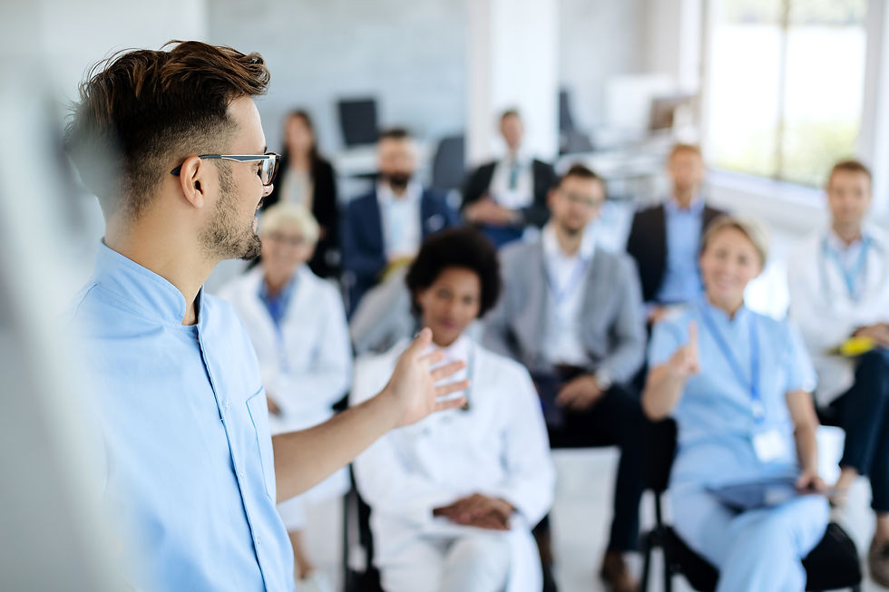 person presenting to staff members at a meeting
