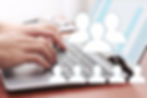 Someone sending message by laptop to multiple recipients