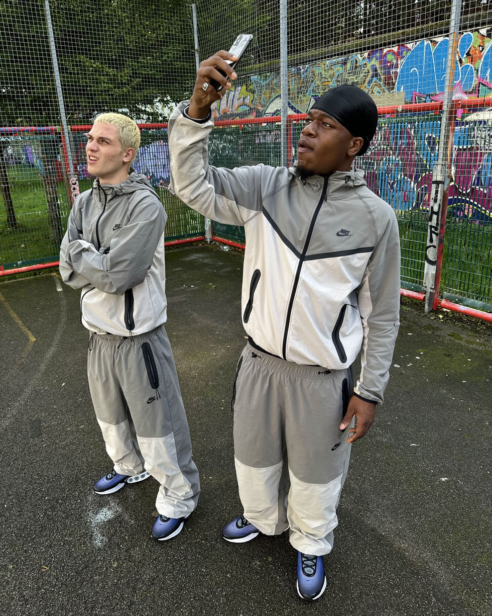 Pair of models wearing matching nike tracksuits