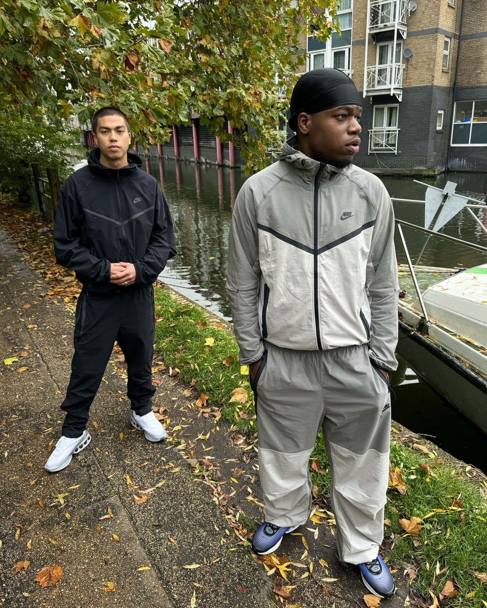 pair of models wearing matching nike tracksuits