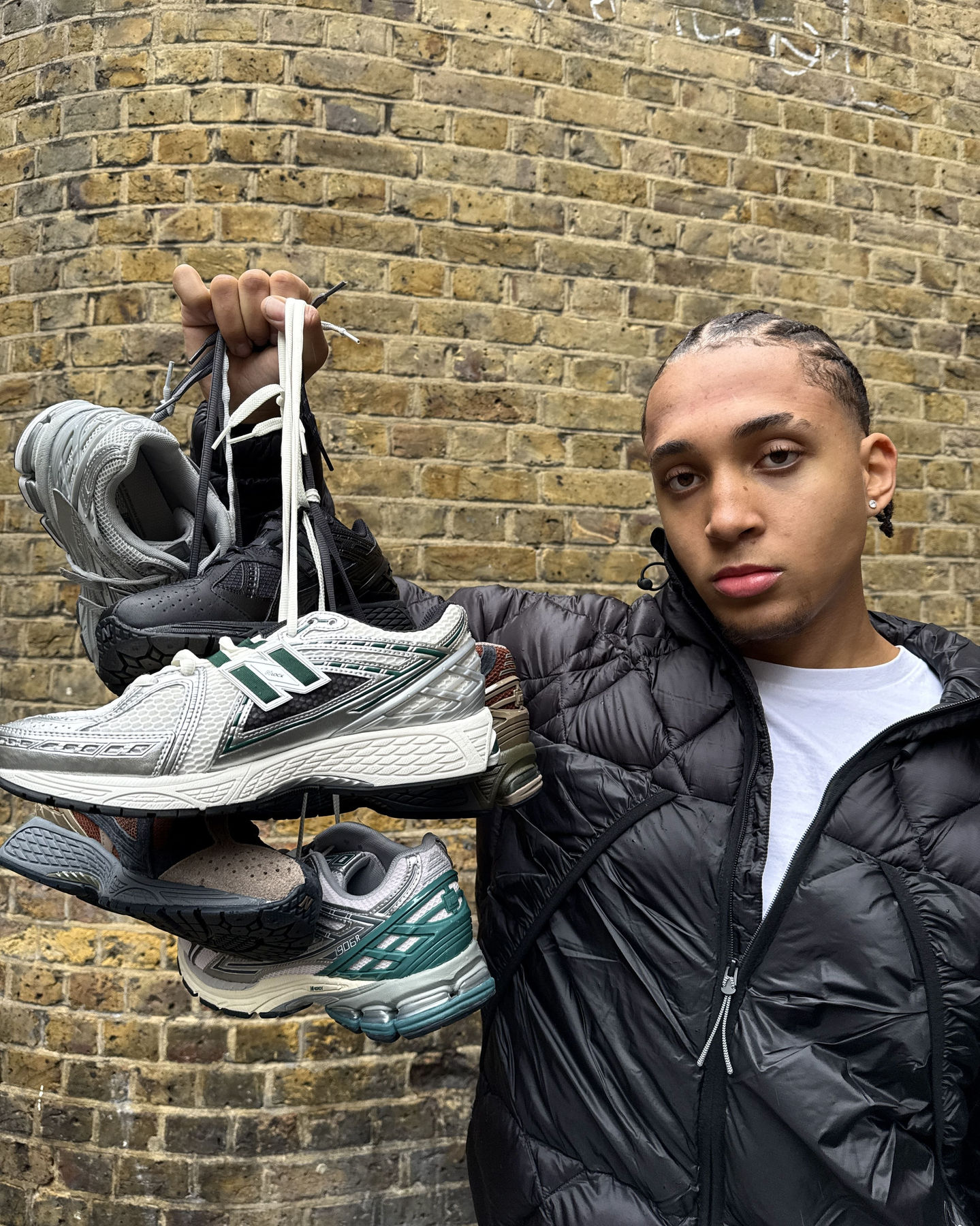 model holding a bunch of streetwear shoes