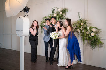 A stunning open air photo booth featuring LED backdrop lighting and stylish custom props. Perfect for weddings and upscale events, this setup brings a modern, luxurious touch to any celebration.