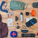 Hiking gear on a table to represent the 10 essentials.