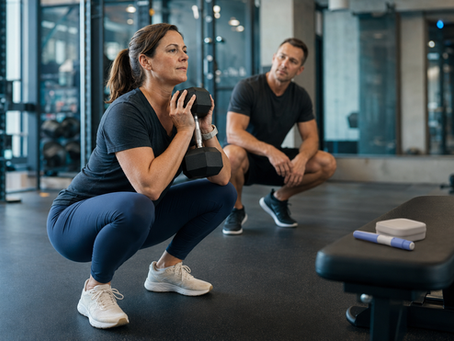 Woman performing resistance training with a coach while taking GLP-1 weight-loss medication.