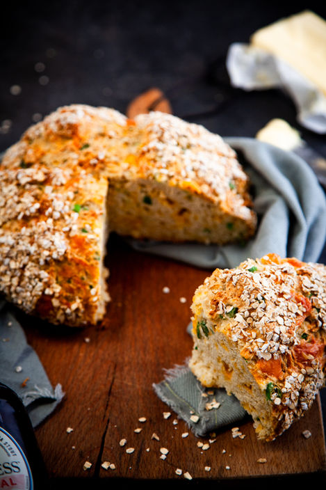 Rustic Guinness, cheese and spring onion soda bread loaf with an oat-covered crust