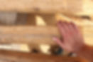 Hand on wood beams