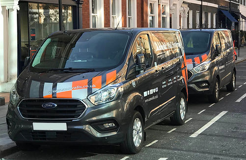 AM Walls company vans parked on street