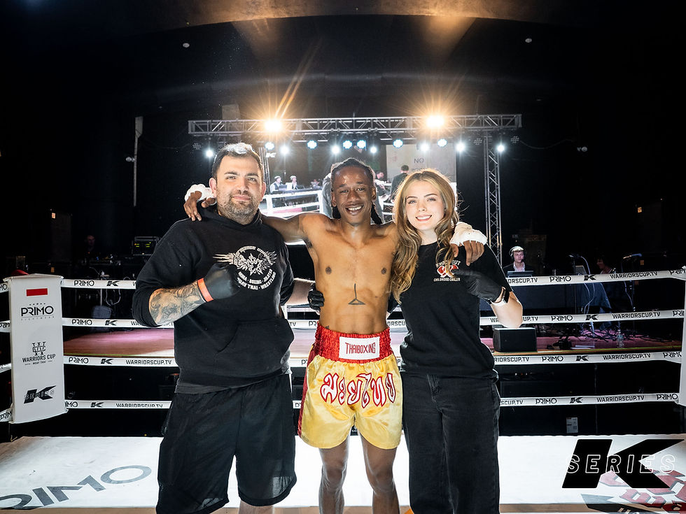 Team poses after winning kickboxing bout