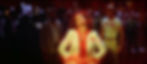 Dale in a white pantsuit and red satin shirt. Her hands are on her abdomen and her head is thrown back with her eyes closed. A red glow surrounds her. Flash Gordon and Zarkov stand behind her with a crowd.