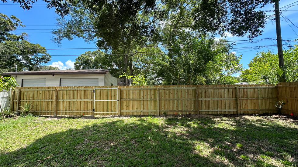 Wooden privacy fence extending along property.
