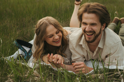 couple laying on glass laughing