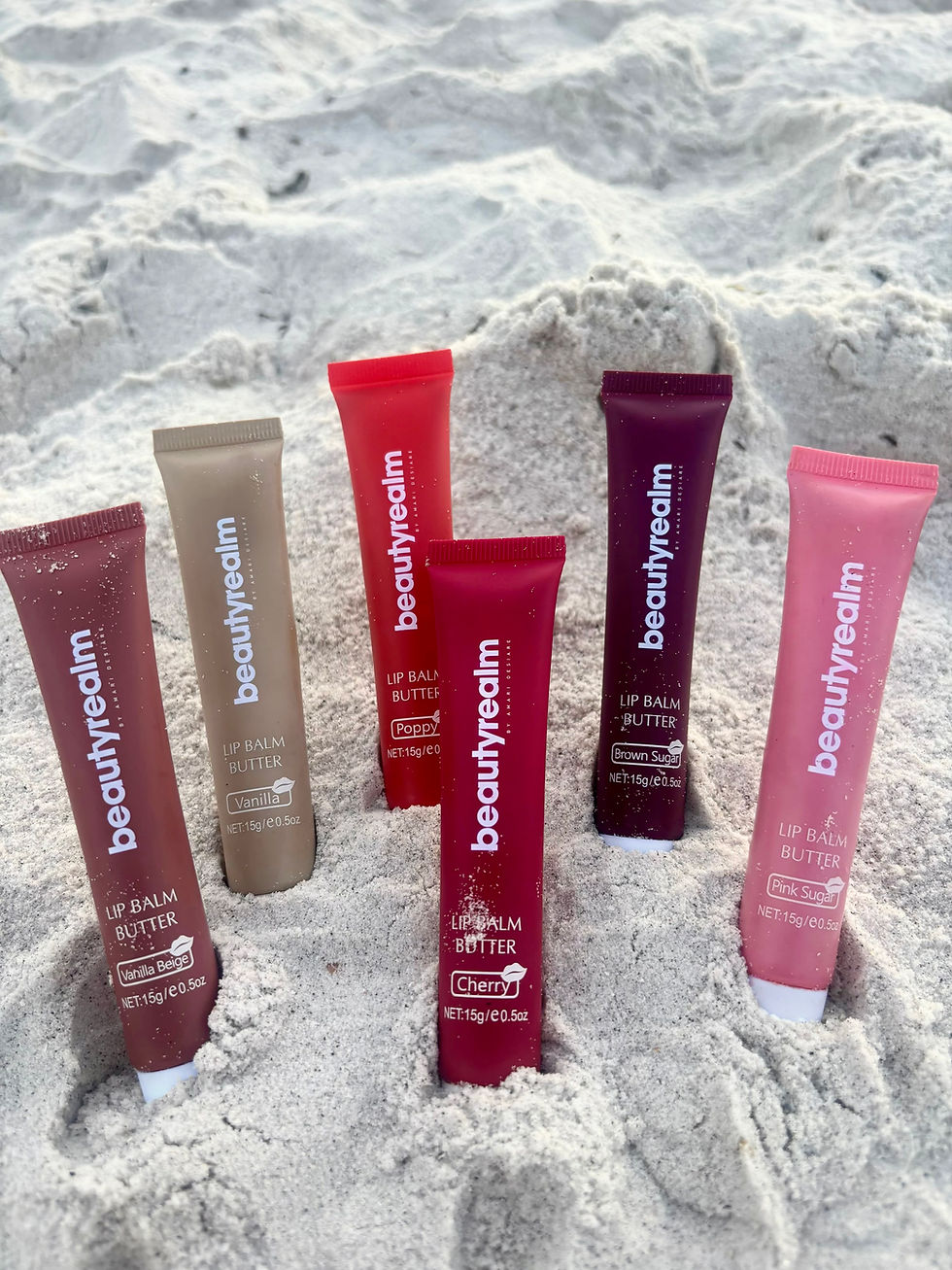 tinted lip glosses in the sand