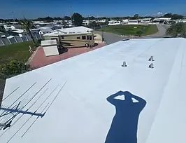 TPO roof white and shiny and free of organics and oxidation afterbsoft washing by clean 2 preserve in american condominium in zephyrhills left side