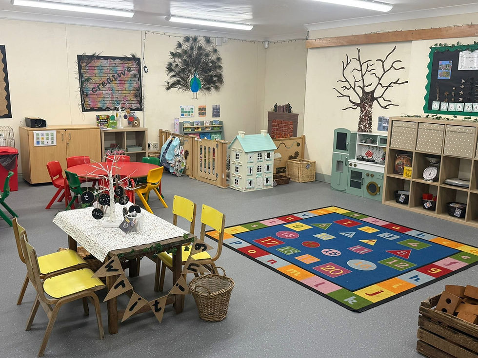 Spacious, colorful preschool classroom with tables, chairs, toys, and learning rug.