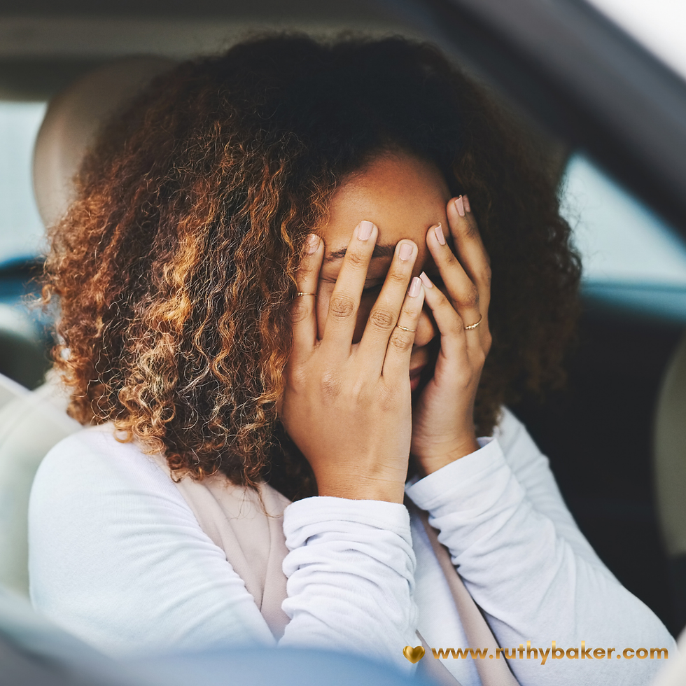 Feeling stuck in life can creep up on you. Woman sits in car hands on her face.