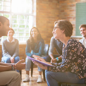 peer providing feedback to colleague in a team setting