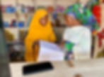 web_lr_Jummai Ibrahim, Provision Store Business Owner, with Laurat Abubakar reviewing Fina