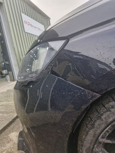 Front fender and headlight of a dark car